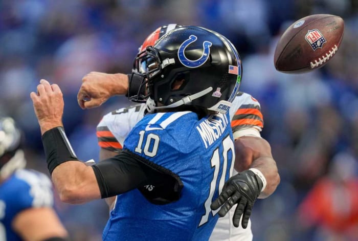 Gardner Minshew is sacked by Myles Garrett as the ball flies through the air behind them being knocked out of his hand